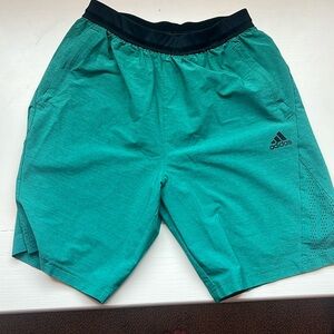Green adidas running shorts